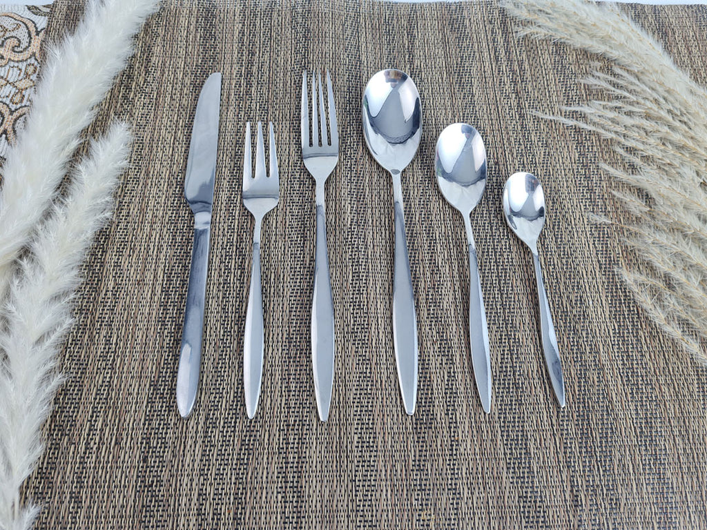 Set of stainless steel silver cutlery including knives, forks, and spoons
