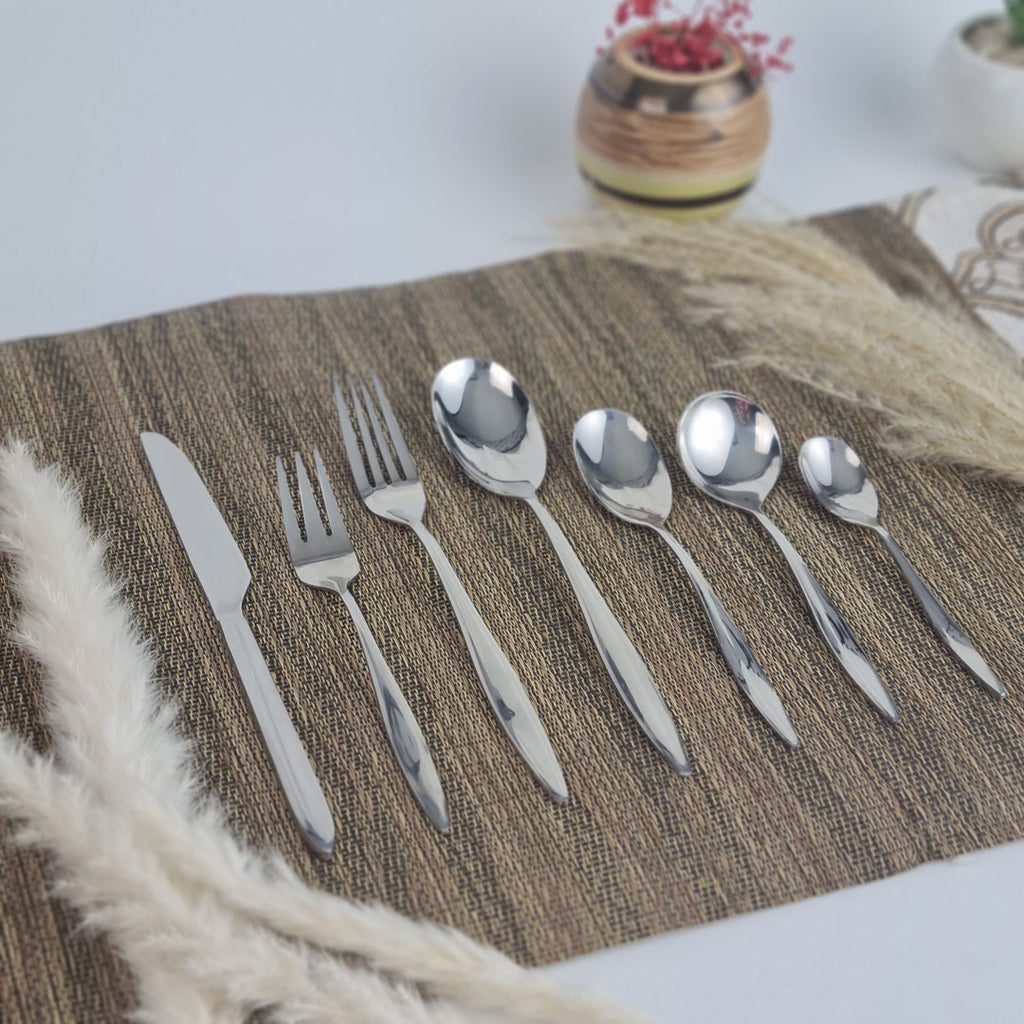 Set of stainless steel silver cutlery including knives, forks, and spoons