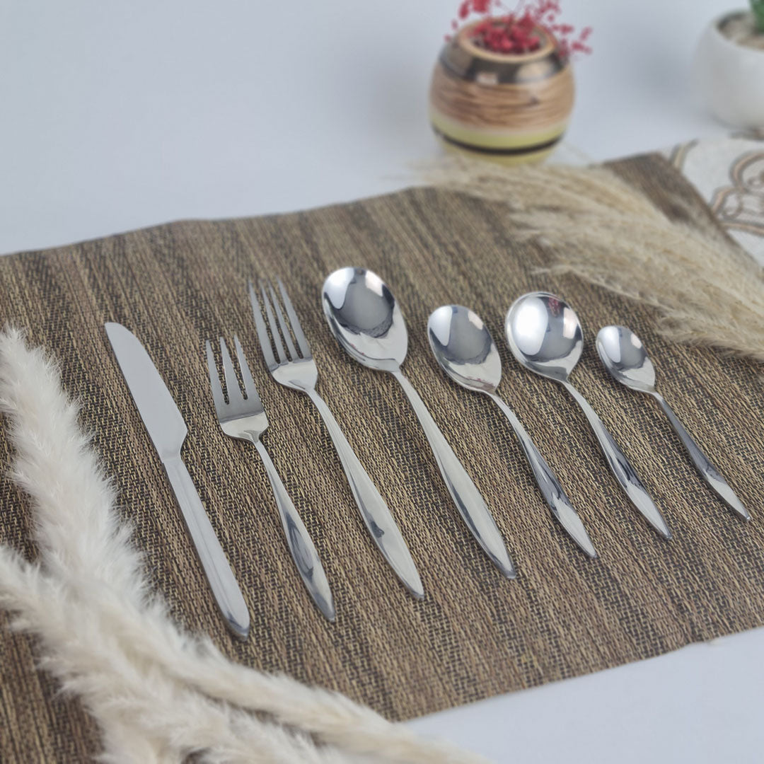 Set of stainless steel silver cutlery including knives, forks, and spoons