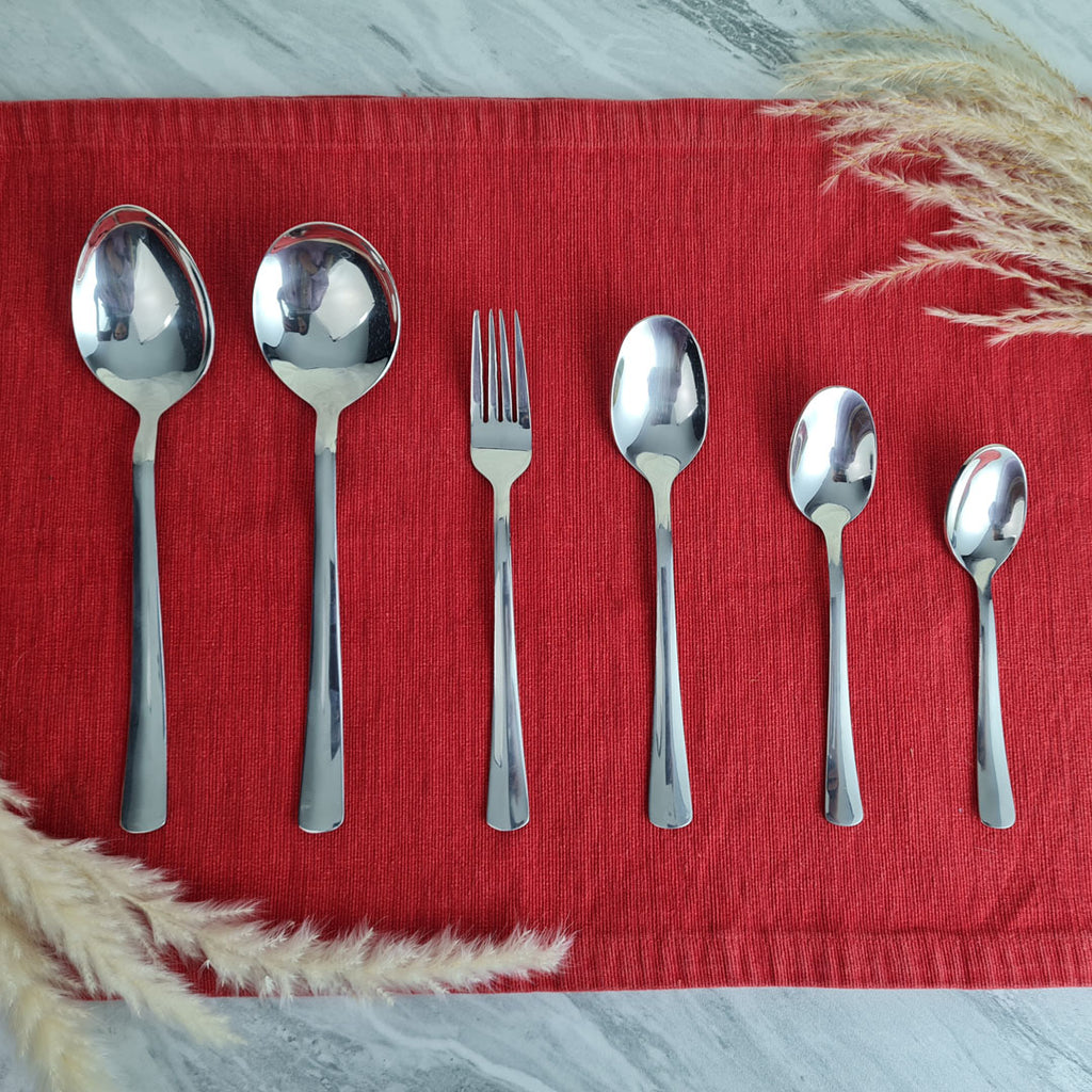 Set of stainless steel silver cutlery spoons and a fork.