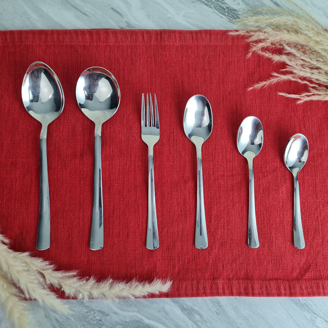 Set of stainless steel silver cutlery spoons and a fork.