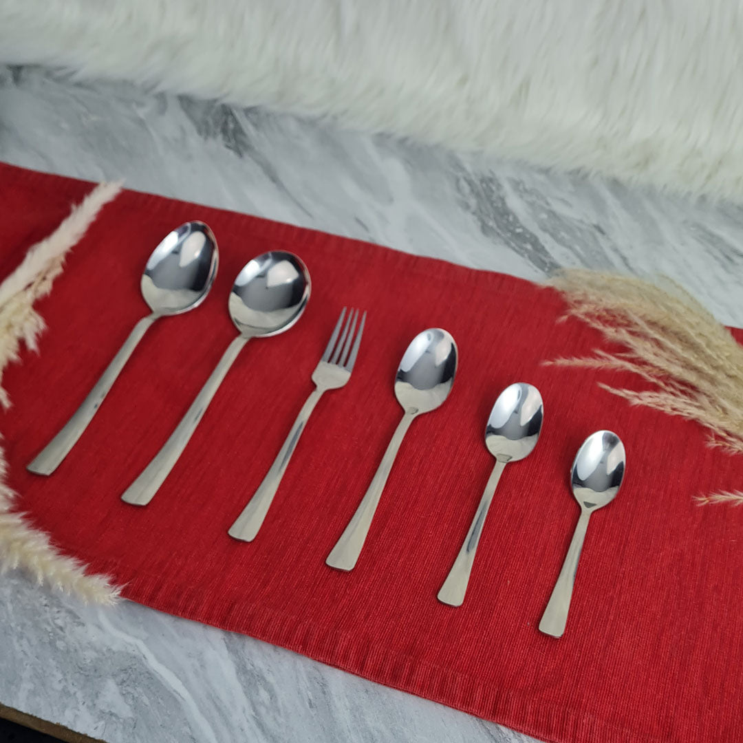 Set of stainless steel silver cutlery spoons and a fork.