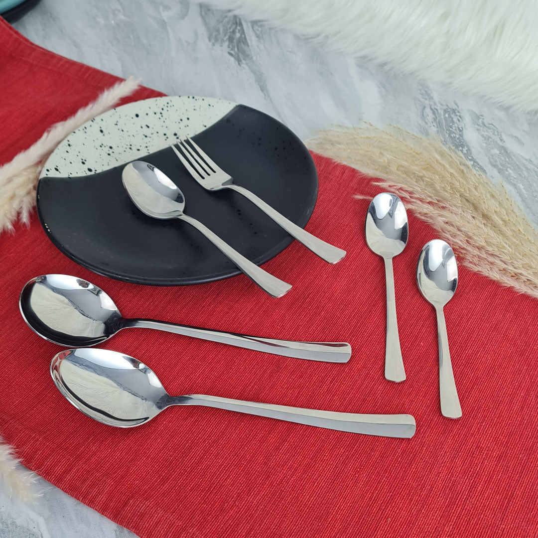 Set of stainless steel silver cutlery spoons and a fork.