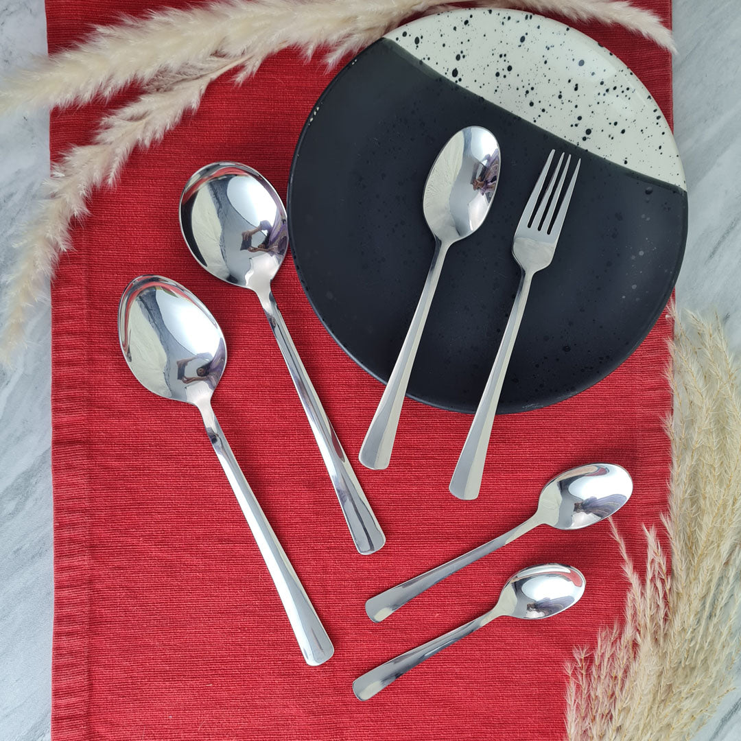 Set of stainless steel silver cutlery spoons and a fork.