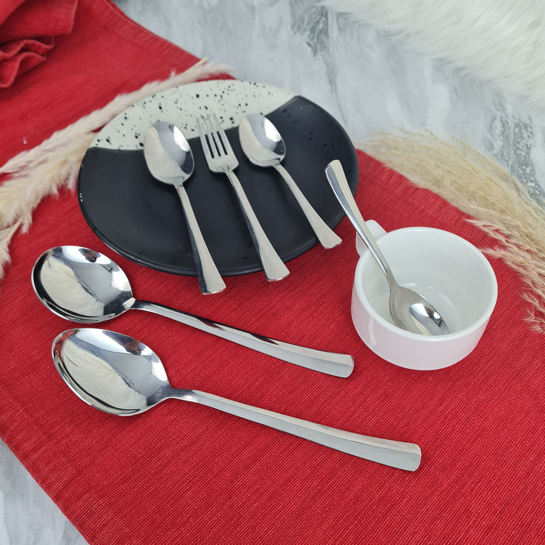 Set of stainless steel silver cutlery spoons and a fork.